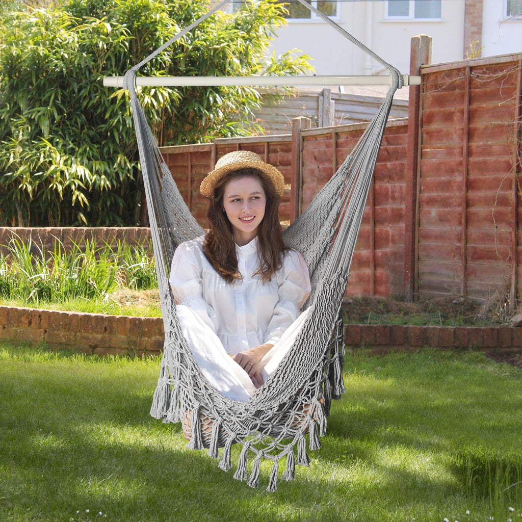 handwoven cotton rope hammock chair with metal spreader shown in use