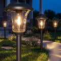 XMCOSY+ Solar Pathway Lights 4 Pack, Metal Glass Solar Garden Light Outdoor